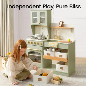 A young girl enjoys imaginative play with the Tiny Land® Wooden Play Kitchen with Storage for Creative Toddlers by Tiny Land, complete with a stove, sink, and shelving bins for effortless organization. This storage play kitchen inspires hours of creative fun with pretend cookware. Text above reads: Independent Play, Pure Bliss.|sage
