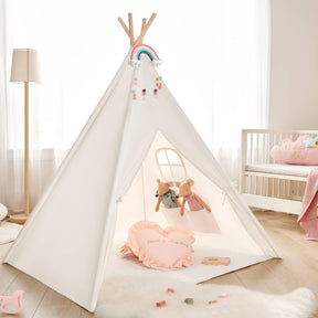 A cozy kids’ room features a white play tent with a rainbow and pom-poms, two plush animals from the Tiny Land® Mystery Surprise Box, a heart pillow, premium wooden toys on the floor, a crib, and soft natural light through curtains.