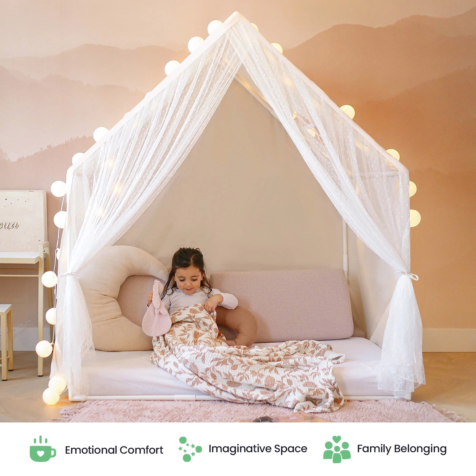 A young girl relaxes on a cozy floor bed beneath the Tiny Land® Kids Tent – Large Cozy Tent with Star Lights, its white canopy adorned with twinkling lights and surrounded by plush pillows and soft blankets. The space is styled in gentle, neutral tones with subtle wall art, making it the ultimate indoor retreat by Tiny Land.|mesh