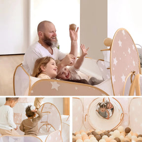 A bearded man and two children play with balls in a star-patterned indoor tent, while nearby, a child stands and another crawls through the Tiny Land® Discovery 5-in-1 Play Tunnel & Ocean Ball Set by Tiny Land.