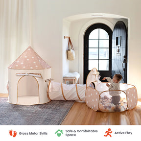 A baby plays in the Tiny Land® Adventure 3-in-1 Play Tunnel & Ocean Ball Set by Tiny Land, which features a star-patterned ball pit connected to a play tunnel and a small play tent, all situated inside a cozy, sunlit room with an arched door. Icons below highlight key skills and benefits.