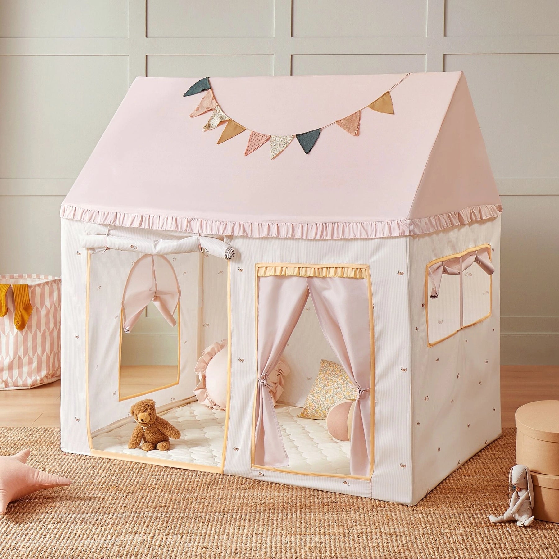 The Tiny Land® Sweet Citrus Kids Play Tent by Tiny Land features a white and pink house-shaped design with pastel bunting, window flaps, and a padded floor—perfect for indoor or outdoor play in any bright, child-friendly space.|pink