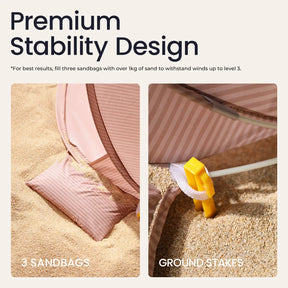 The Tiny Land® Baby Beach Tent in Blush Pink is shown secured on sand with a sandbag and yellow ground stake, highlighting its UV protection and Premium Stability Design for outdoor fun. Recommended by Tiny Land for safe, stable use.|Blush Pink