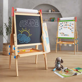 Two Tiny Land® 3-in-1 Art Easels for Kids stand in a playroom. The front, adjustable-height easel from Tiny Land features ABCDE and a sun drawn in chalk, while the back displays colorful magnetic letters on its whiteboard surface. A stuffed bunny and an open book rest on a rug in the foreground.|red