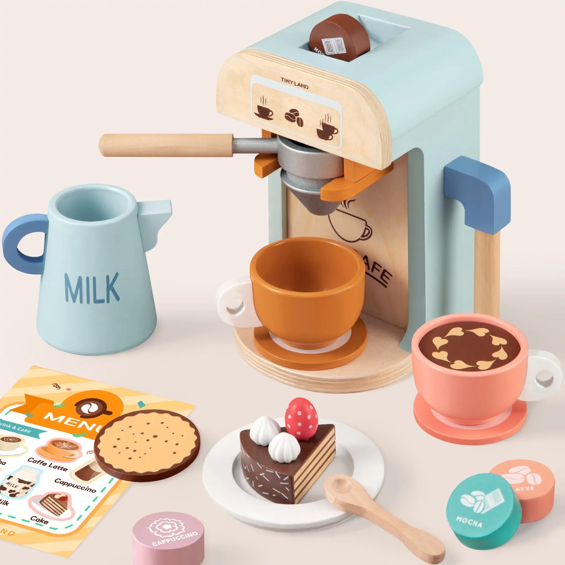 The Tiny Land® Luxury Kitchen Playset by Tiny Land includes wooden cups, milk jug, cookies, desserts, coffee pods, spoon, and a colorful menu—perfect for any wooden or pretend play kitchen fun on a pale surface.
