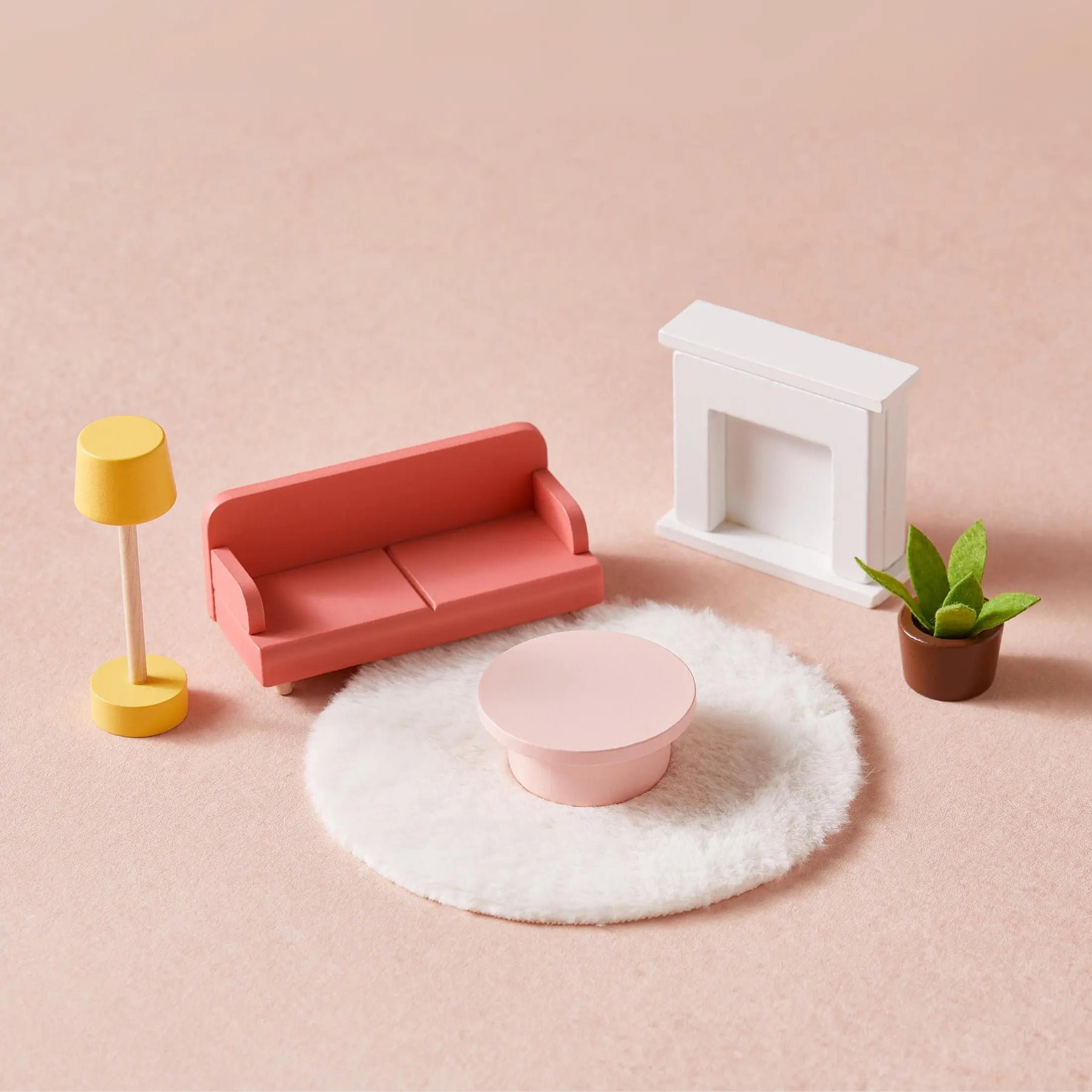 The Sweet Dreams Playset by Tiny Land features a miniature living room set with a pink sofa, round coffee table, white rug, fireplace, yellow lamp, and green potted plant—perfect dollhouse furniture for any girl’s Pink Dollhouse or Playhouse.|pink