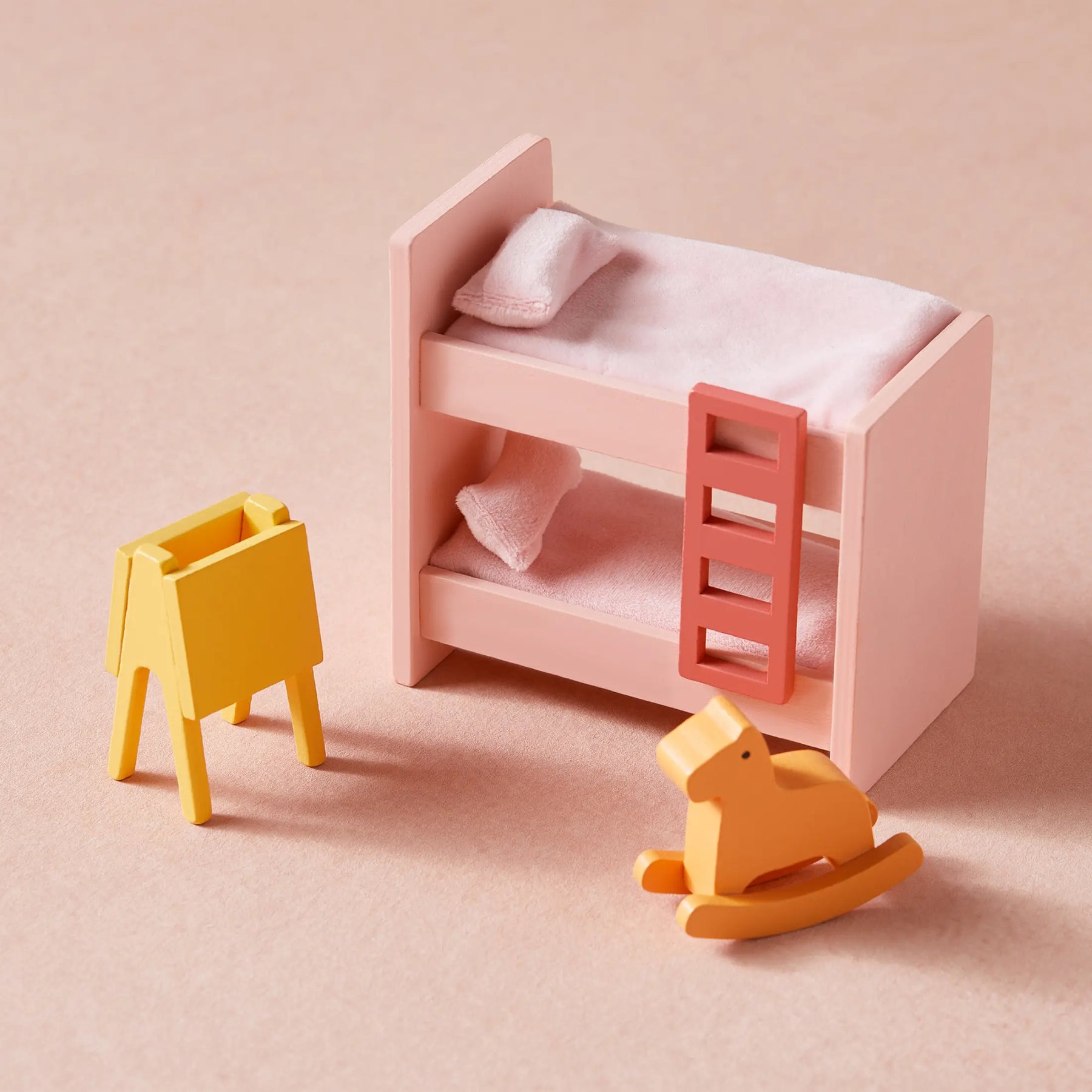 The Tiny Land Sweet Dreams Playset — Pink Dollhouse + Pink-White Playhouse includes a pink bunk bed with pillows and blankets, a yellow easel, and a rocking horse—ideal wooden dollhouse furniture for any girl's playroom.|pink