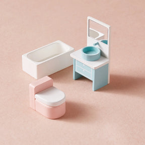 The Tiny Land Sweet Dreams Playset — Pink Dollhouse + Pink-White Playhouse features a white bathtub, pink toilet, and blue-white vanity with mirror, making it ideal wooden furniture for any girls' dollhouse. Arranged on a light pink surface.|pink