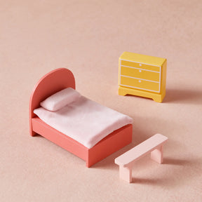 The Sweet Dreams Playset — Pink Dollhouse + Pink-White Playhouse by Tiny Land features a pink bed, soft white blanket, yellow dresser with drawers, and light pink bench—an ideal addition to any dollhouse collection for girls.|pink