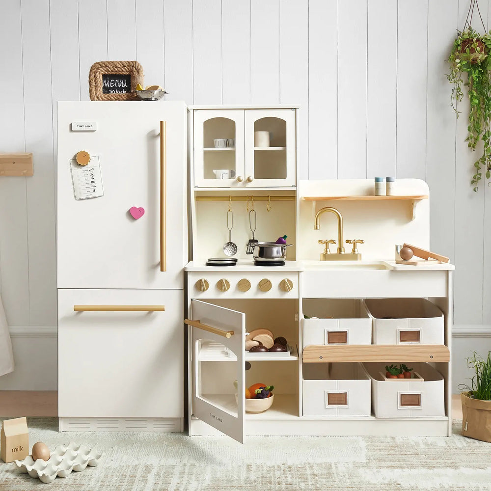 The Tiny Land® Play Kitchen Fridge is a wooden cabinet refrigerator for kids, featuring organized shelves for toy food and pots. Perfect as an accessory in any play kitchen setup from Tiny Land, with stylish wooden accents and ample storage space.