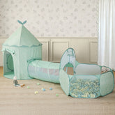 The Tiny Land® Green Adventure 3-in-1 Play Tunnel & Fun-Shapes Ocean Ball Set features a pastel green tunnel connecting to a ball pit filled with soft balls, all set in an elegant, softly lit room with floral wallpaper.