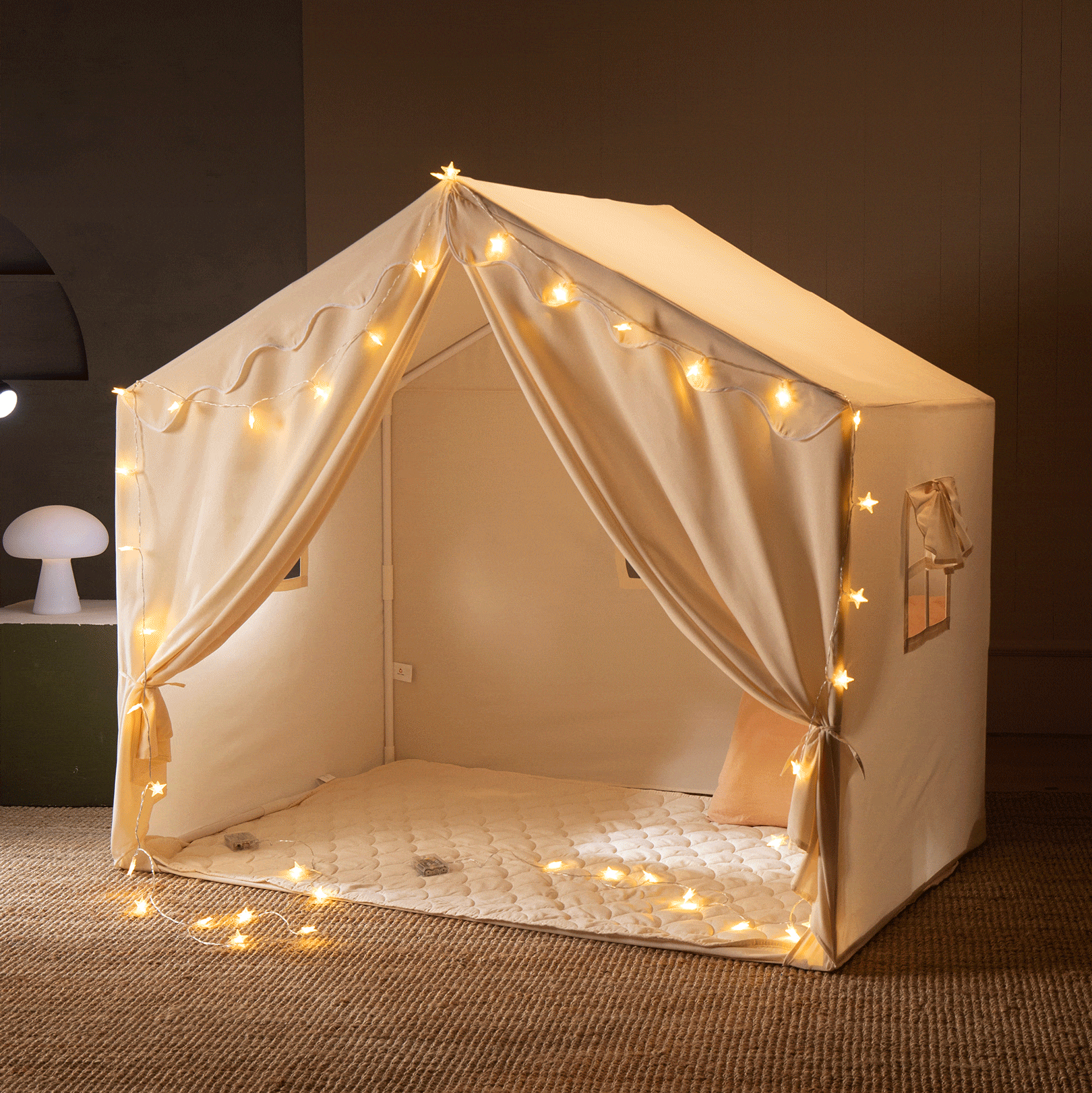 The Tiny Land® Kids Tent – Large Cozy Tent with Star Lights by Tiny Land features cream fabric, star string lights, a quilted mat, open curtains, and a pillow inside to create a warm and inviting play space for kids.|fabric