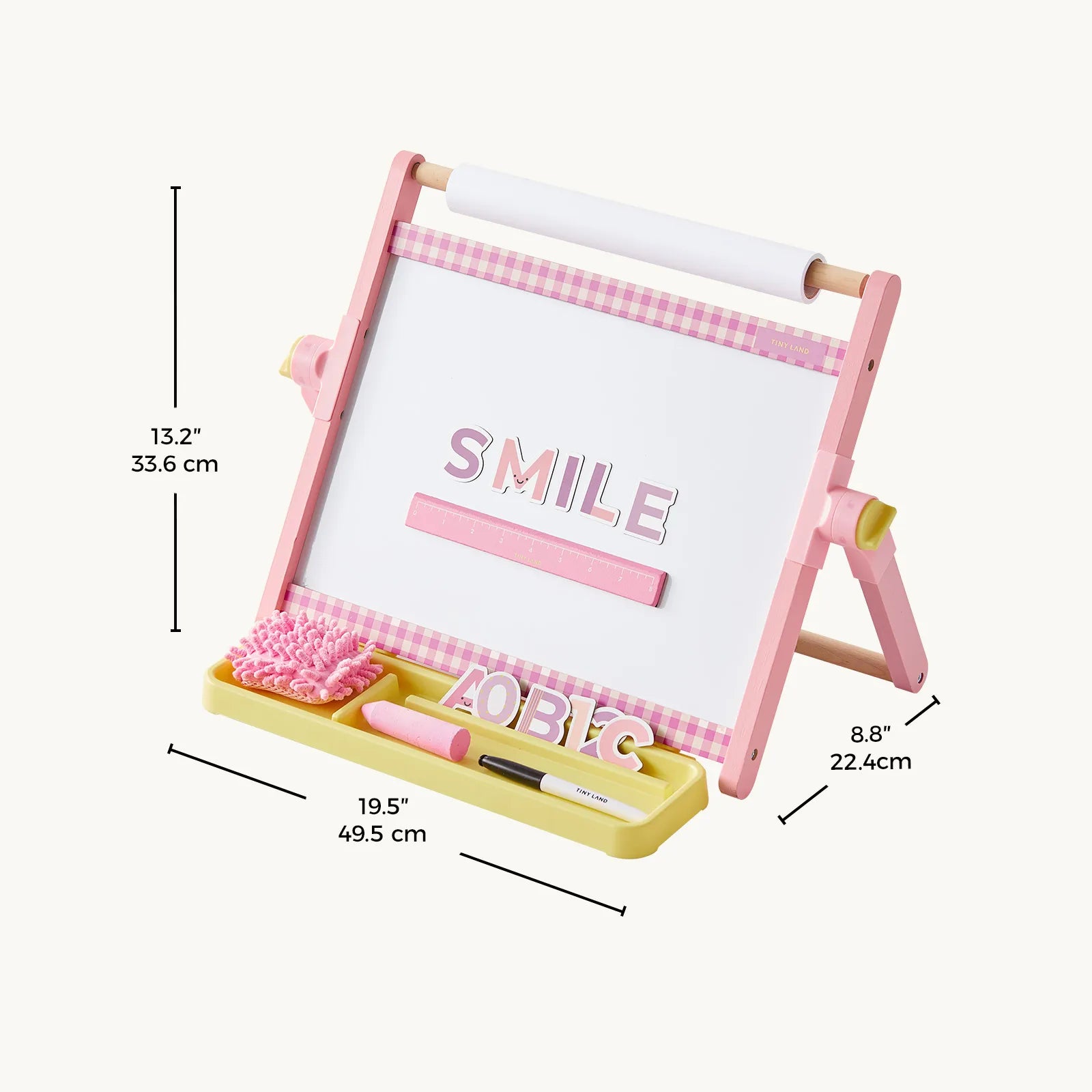The Tiny Land® Double-Sided Magnetic Tabletop Easel from Tiny Land is a pink and white adjustable kids' art station featuring a measuring tray, marker, eraser, and letter tiles spelling "SMILE." This versatile easel includes a magnetic whiteboard surface and measures 13.2" H x 8.8" D x 19.5" W.|Pink