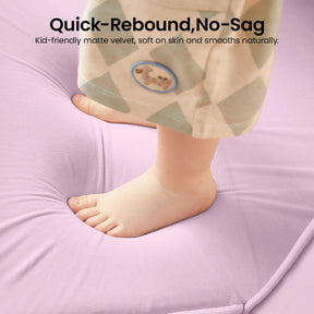 A child’s bare feet sink into the plush, light purple surface of the Tiny Land® GentleSnug Kids Sofa Chair, leaving a gentle indentation. Text above highlights its quick-rebound and no-sag features from Tiny Land, describing it as kid-friendly and soft—ideal for use as a children’s nap mat or a flip-open chair, offering versatile comfort during playtime or rest.|Light Purple