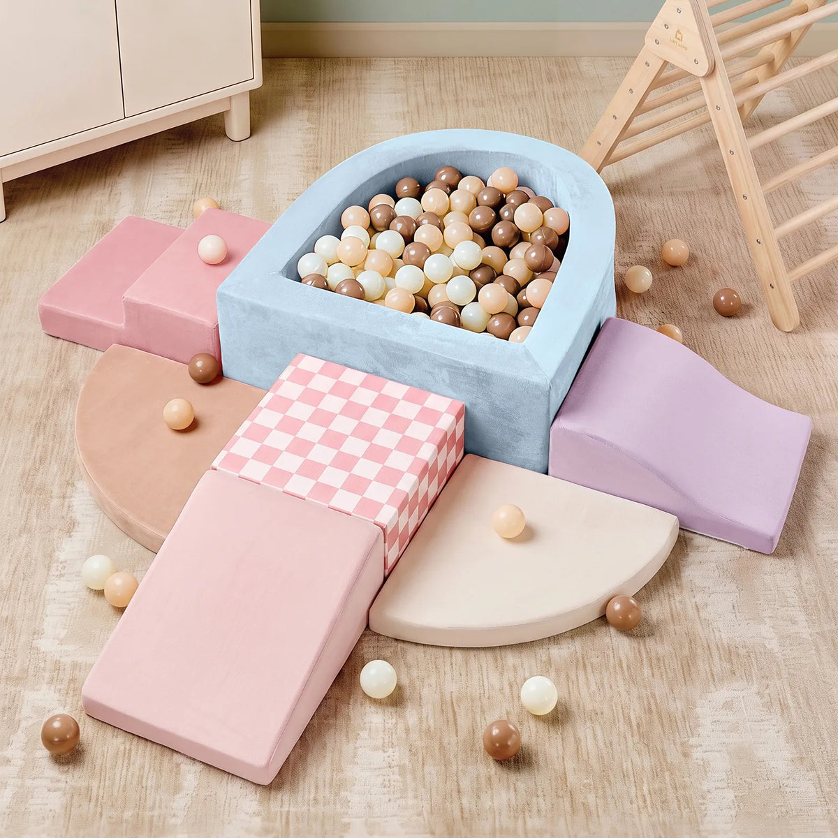 Experience the Tiny Land® Violet PlayNest Climbing & Ball Pit Set by Tiny Land—featuring pastel-colored foam ramps, arches, and a sensory ball pit filled with beige, white, and brown balls. This inviting setup includes climbing blocks arranged on a light wood floor beside wooden furniture and a climbing structure for endless soft play fun.|Blue