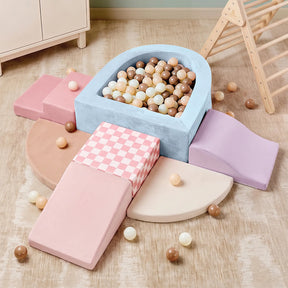 Experience the Tiny Land® Violet PlayNest Climbing & Ball Pit Set by Tiny Land—featuring pastel-colored foam ramps, arches, and a sensory ball pit filled with beige, white, and brown balls. This inviting setup includes climbing blocks arranged on a light wood floor beside wooden furniture and a climbing structure for endless soft play fun.|Blue