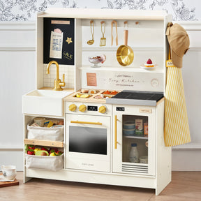 The Tiny Land® BistroSwitch Play Kitchen by Tiny Land features a sink, stove, oven, shelves, utensils and accessories above, play food like eggs and veggies on display, an apron and hat on the side, plus baskets with pretend fruits and vegetables.|White