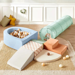 Transform your indoor playground with the Tiny Land® PlayNest Climbing Ball Pit Set with Tunnel. This soft play area features pastel foam shapes—including a slide, steps, tunnel, and a unique curved ball pit filled with beige, brown, and white balls—inviting little ones to explore under the trusted Tiny Land name. A cuddly stuffed bunny sits inside the tunnel while cozy cushions and a decorative wreath create an inviting background.|Blue