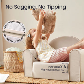 A young child sits on the Tiny Land® GentleSnug Kid Chair in beige, lifting a stuffed animal overhead. Highlighted features include No Sagging, No Tipping, Reinforced Magic Tape, and Upgraded 31A High-Resilience Foam—making this Tiny Land chair the perfect comfortable playroom furniture for your little one.|Beige