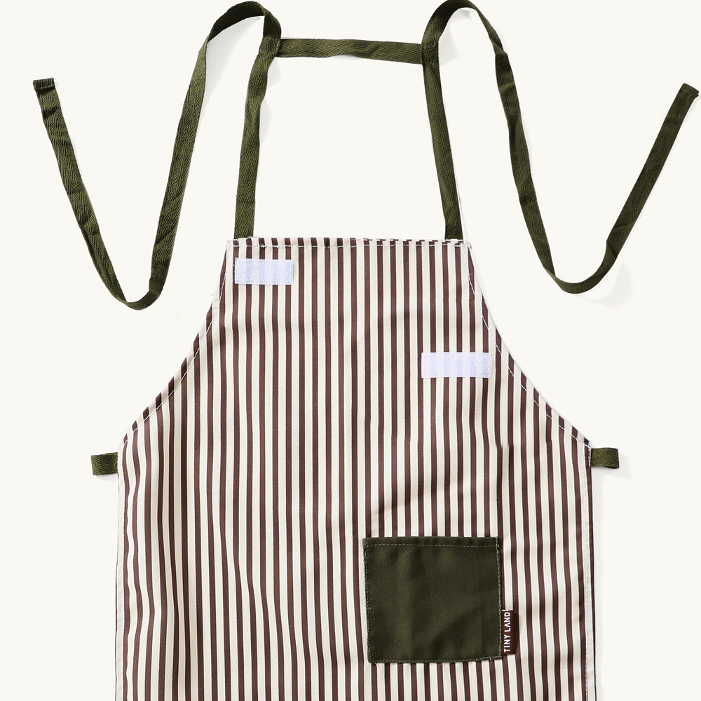 A stylish Tiny Land® BistroSwitch Play Kitchen apron with brown and white stripes, olive green pocket, and matching ties from Tiny Land, perfect for pretend play or as a chic addition to your play kitchen accessories.|Green