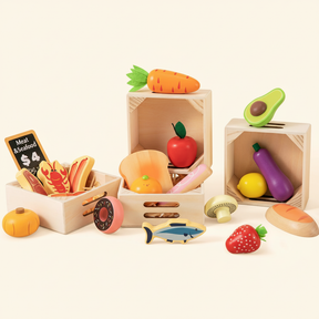 The Tiny Land® Play Kitchen Accessories set by Tiny Land Play Food features wooden fruits, veggies, seafood, and bread—plus a carrot, avocado, donut, lobster, shell, and $4 meat & seafood sign—arranged in three crates for realistic toddler play.