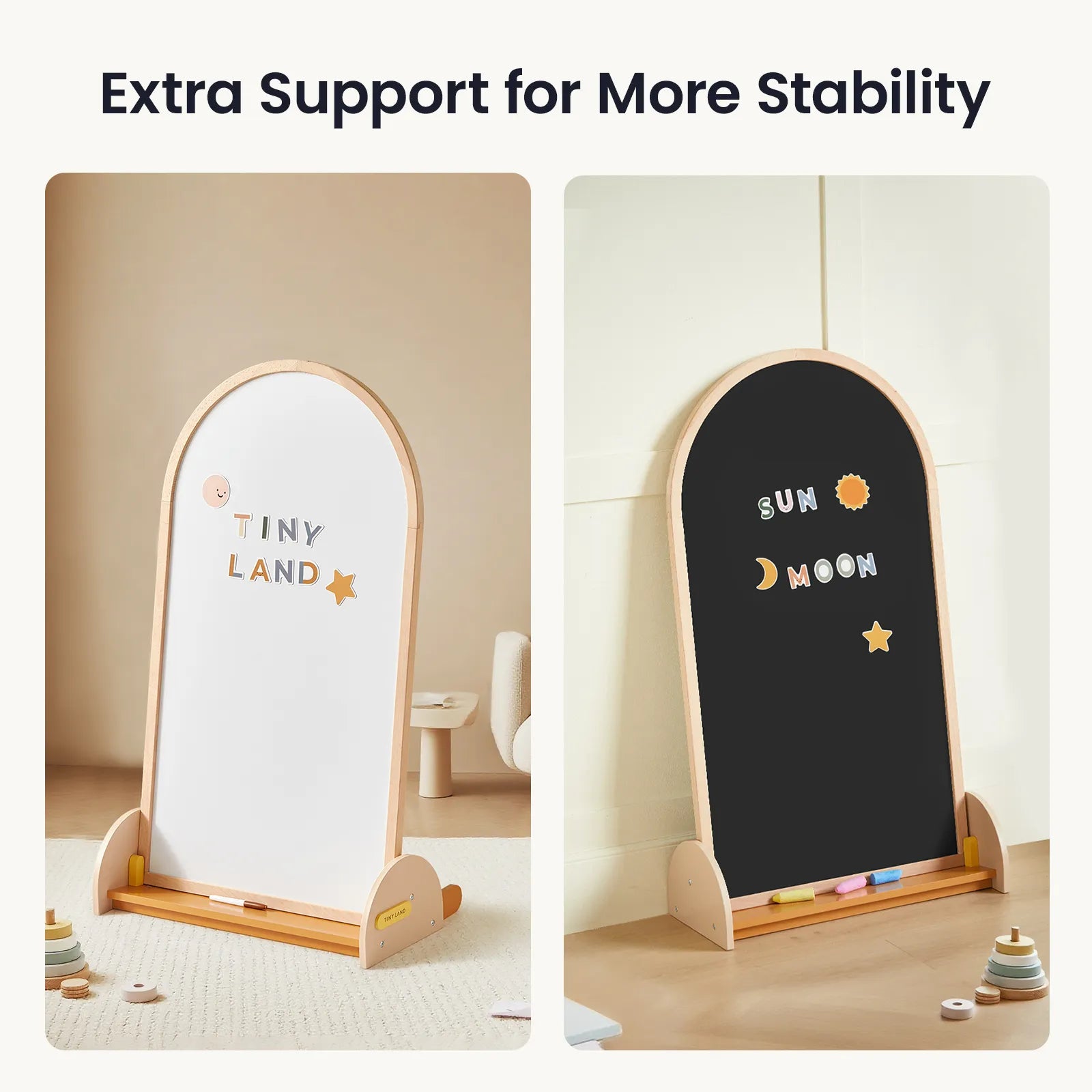 Two wooden-framed easels, including the Tiny Land® Double-Sided Arched Magnet Chalkboard & Art Kit—one side featuring a TINY LAND whiteboard and the other a SUN MOON chalkboard—stand in a light-colored room with toys and a small table in the background, making an ideal kids’ art easel or perfect addition to any child's art accessory collection from Tiny Land.